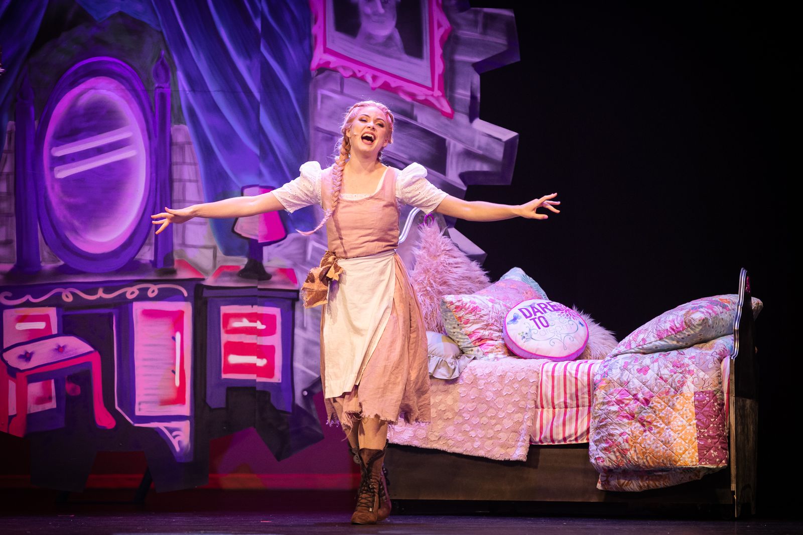 Cinderella in her rags in a pink and purple bedroom set, Cinderella pantomime by Zealous Productions, December 2021