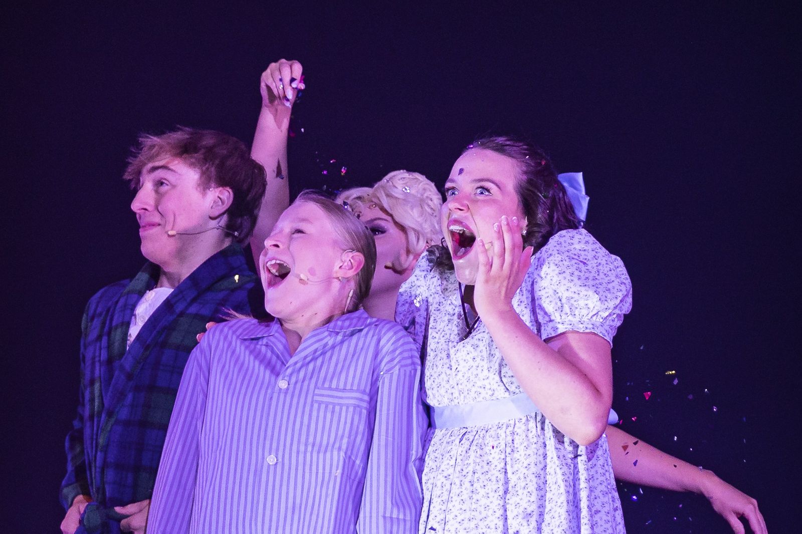 Wendy and the Darling boys in their nightclothes gasp as Tinker Bell sprinkles fairy dust, Zealous Productions' Peter Pan pantomime, Regal Theatre Perth, December 2022