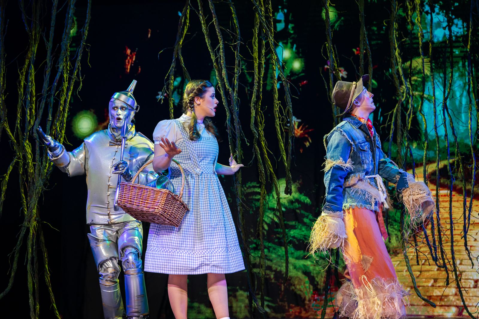 Dorothy with the Tin Man and the Scarecrow in the forest, The Wizard of Oz pantomime by Zealous Productions, December 2025